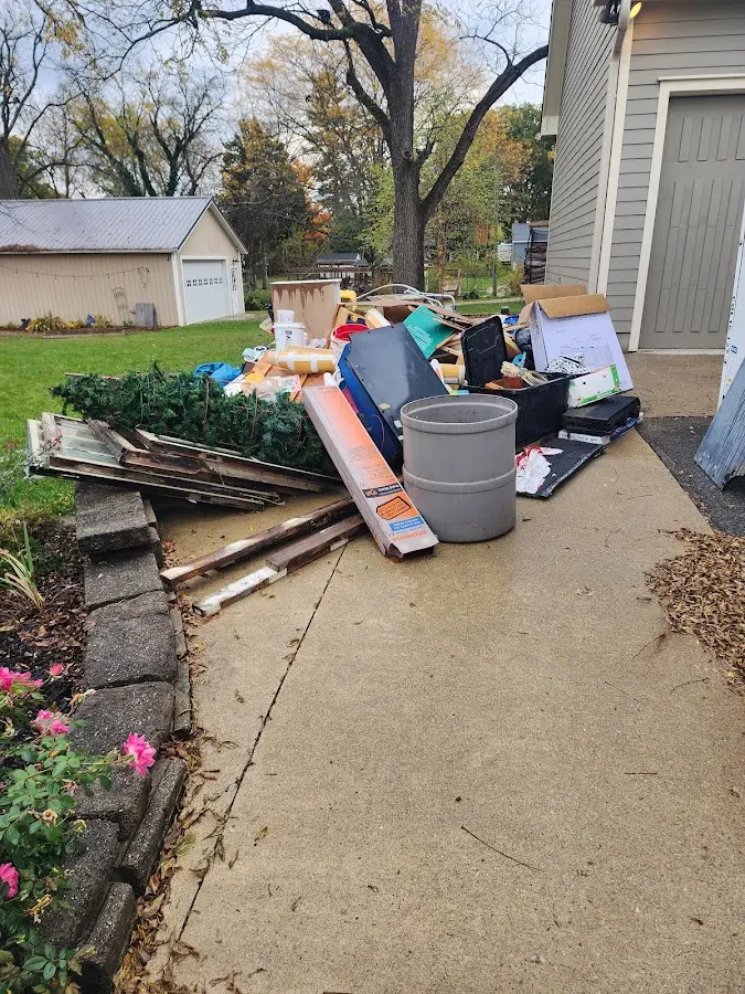Dumpster being loaded with debris for Estate Cleanout Dumpster Rental in Tuckahoe